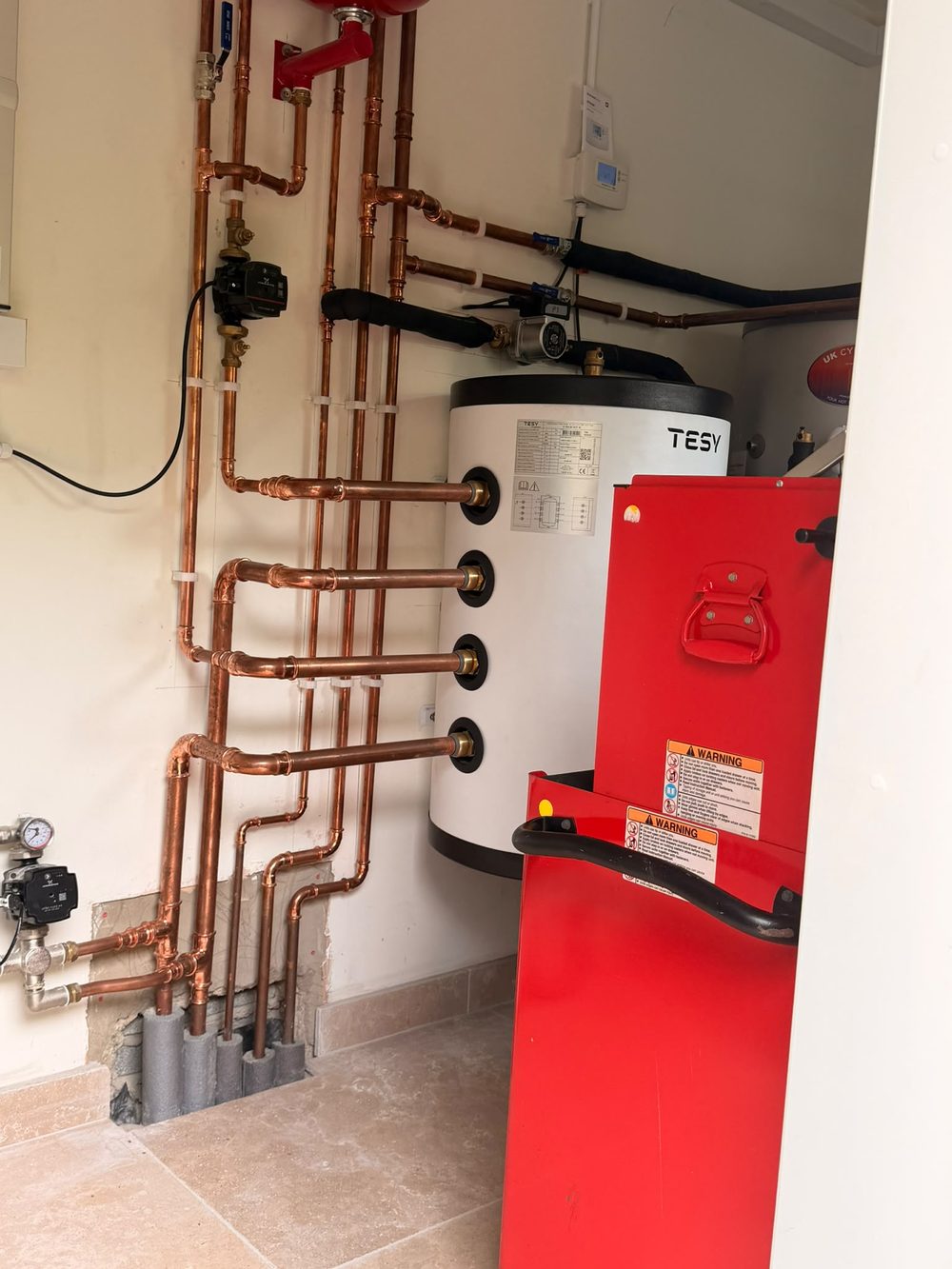 Heating plant room with cylinders and pipework installed by Allied Heating