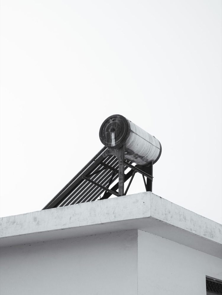 Evacuated tube solar thermal collector mounted on a rooftop